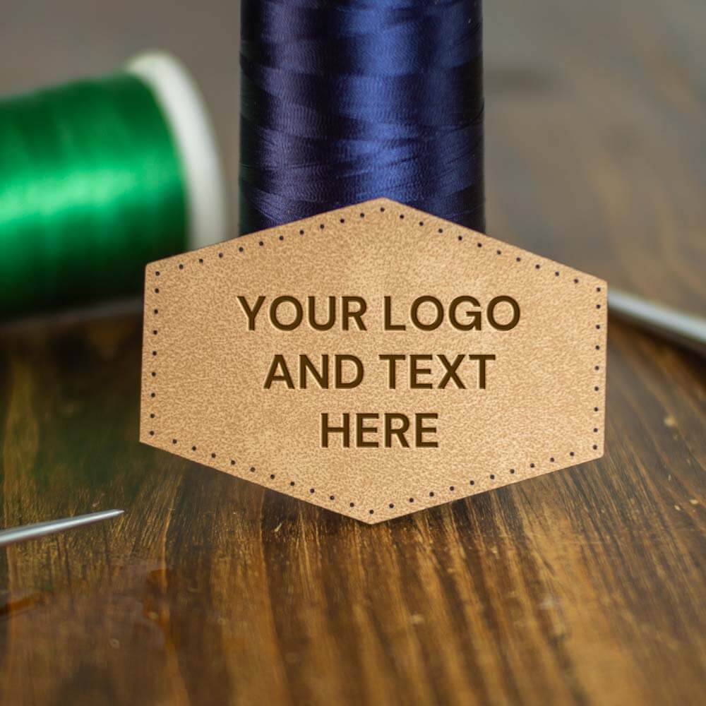 Hexagon Faux Leather Patch laser engraved with your logo or graphic. With cut stitch holes ready for sewing on to your choice of clothing, hat or garment.